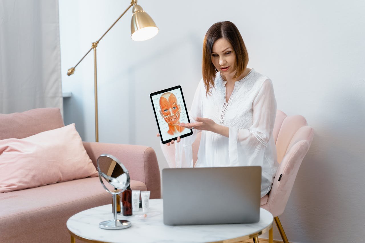 Woman Showing a Picture of the Anatomy of Face Muscles